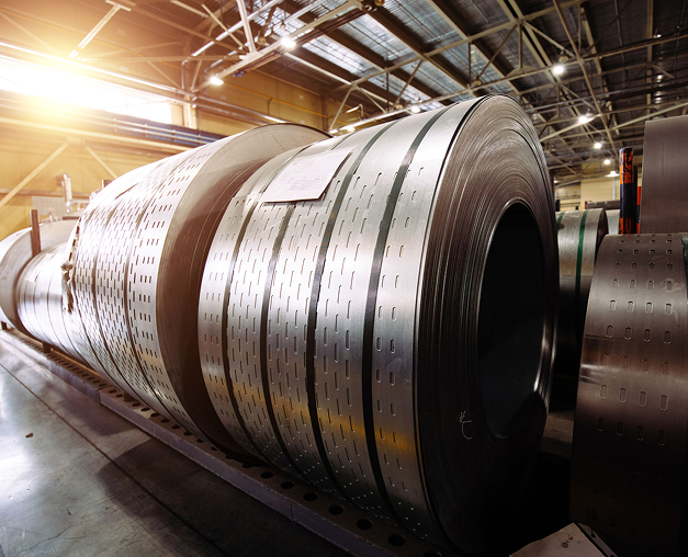 Large steel coils in a factory setting.